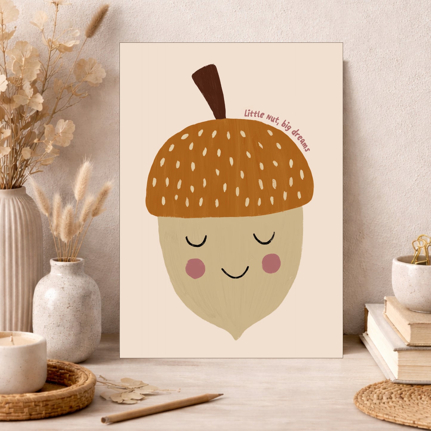 Illustration of a smiling acorn with rosy cheeks on a beige background, featuring the text 'Little nut, big dreams'